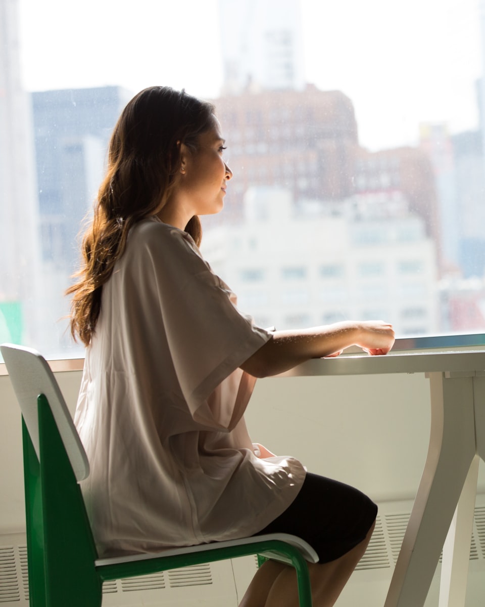 Someone working quietly at a desk by a window